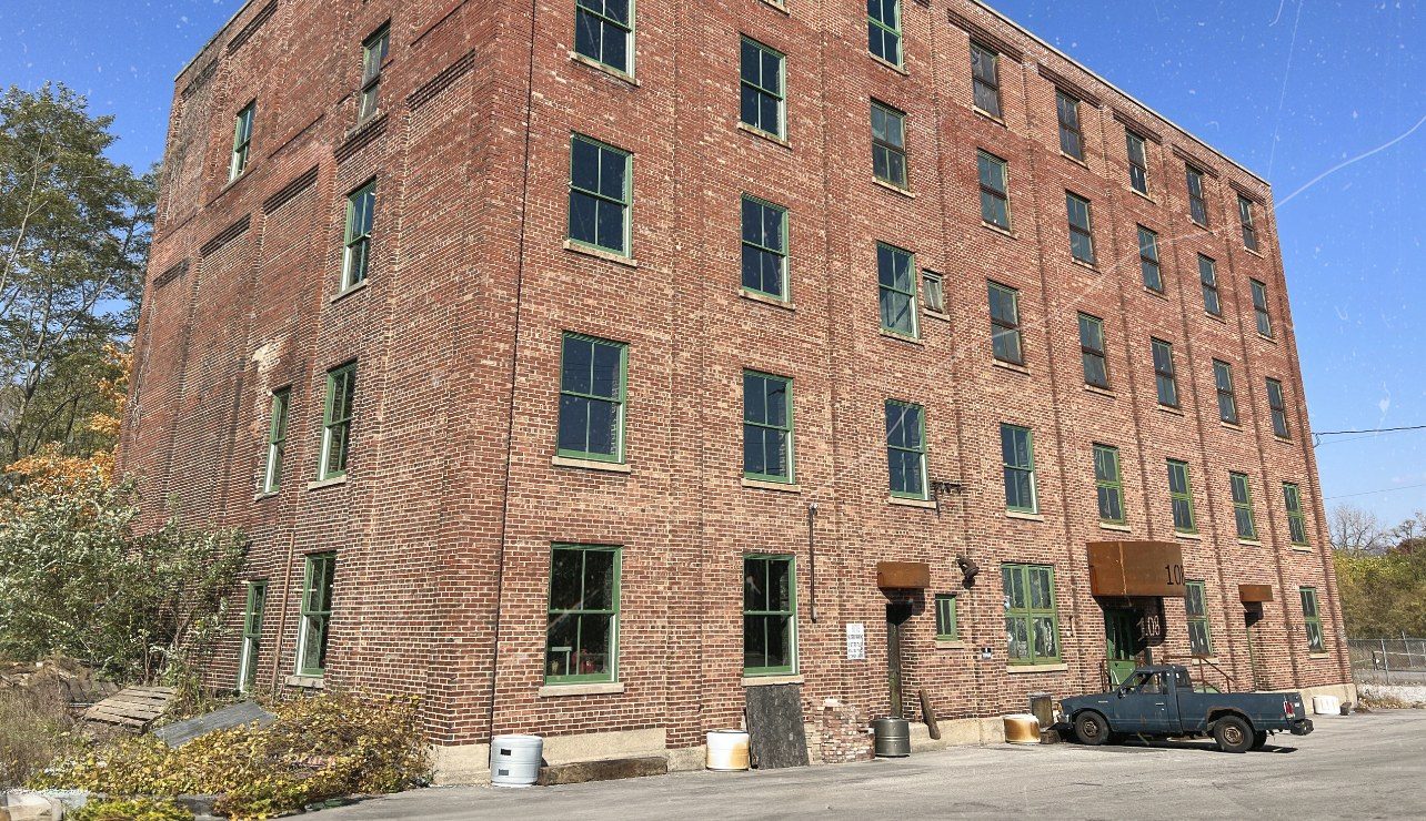 The RUST building, a red brick building with green windows at 108 E North St